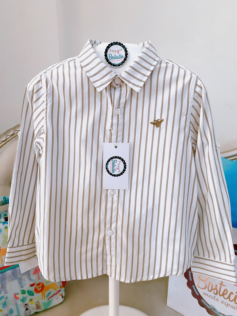 Camisa beige líneas doradas.
